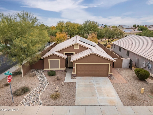 view of front of house with a garage and solar panels