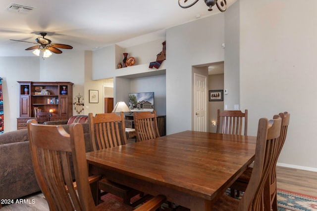 dining space with hardwood / wood-style flooring and ceiling fan