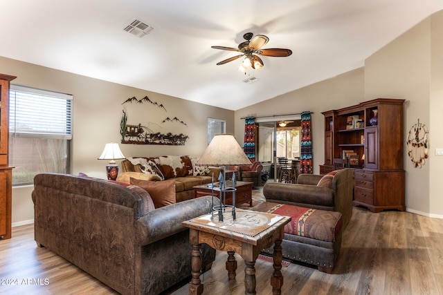 living room with ceiling fan, hardwood / wood-style floors, and vaulted ceiling