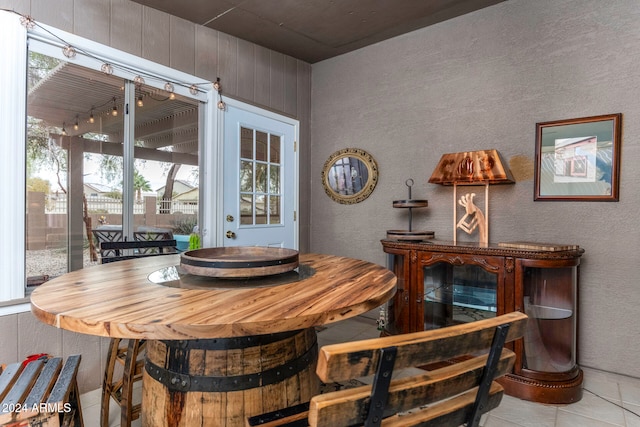 tiled dining space with wood walls