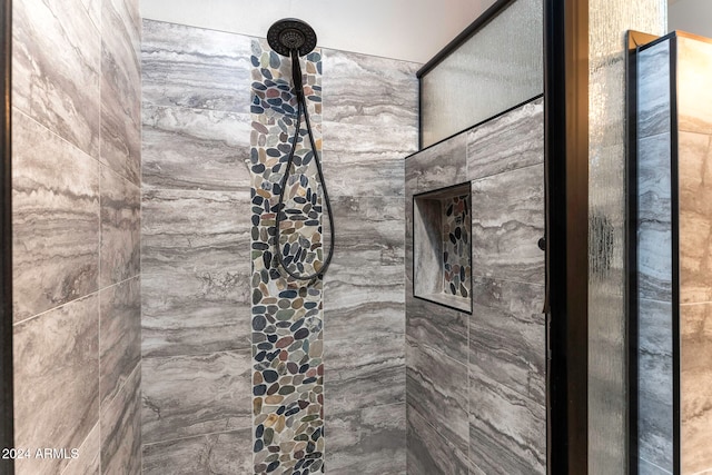 bathroom with tiled shower