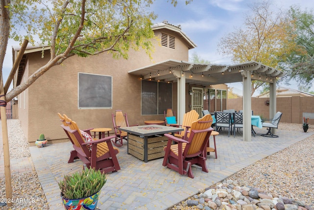 view of patio featuring a pergola and an outdoor fire pit