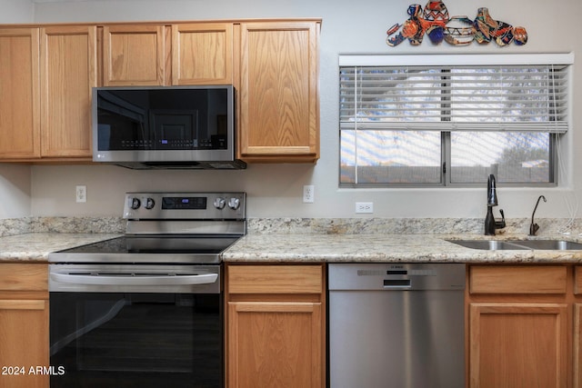 kitchen featuring light brown cabinets, sink, and appliances with stainless steel finishes