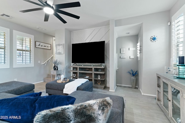 living room with ceiling fan and light wood-type flooring