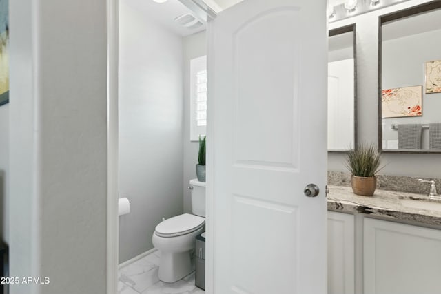 bathroom with vanity and toilet