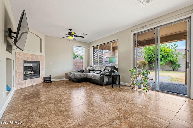 6245 W Maya Dr, Phoenix, AZ 85083 - living area with baseboards, a ceiling fan, and a fireplace
