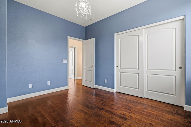 6245 W Maya Dr, Phoenix, AZ 85083 - unfurnished bedroom with a chandelier, wood finished floors, baseboards, and a closet
