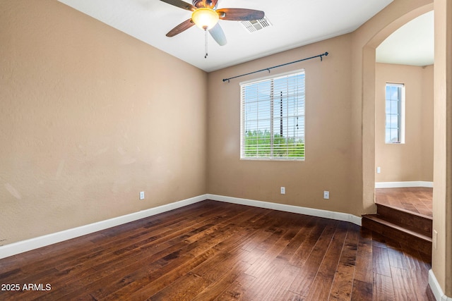 6245 W Maya Dr, Phoenix, AZ 85083 - spare room featuring arched walkways, dark wood finished floors, plenty of natural light, and ceiling fan