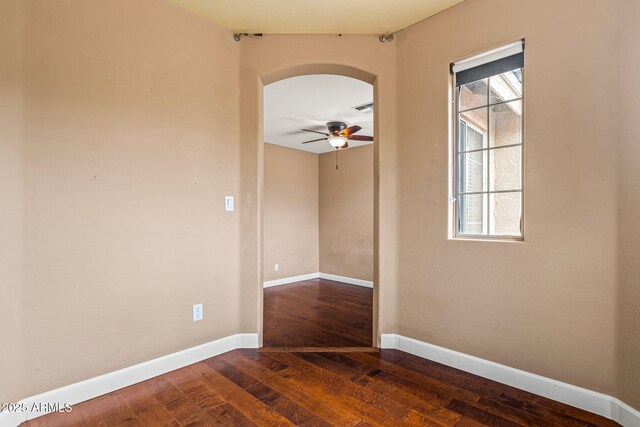 6245 W Maya Dr, Phoenix, AZ 85083 - spare room with arched walkways, dark wood-style floors, ceiling fan, and plenty of natural light