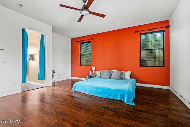 6245 W Maya Dr, Phoenix, AZ 85083 - bedroom with hardwood / wood-style flooring, arched walkways, baseboards, and ceiling fan