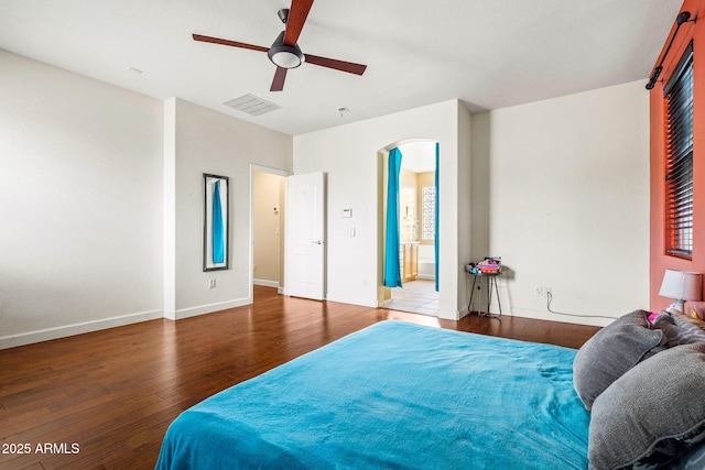 6245 W Maya Dr, Phoenix, AZ 85083 - bedroom featuring wood finished floors, arched walkways, baseboards, and a ceiling fan
