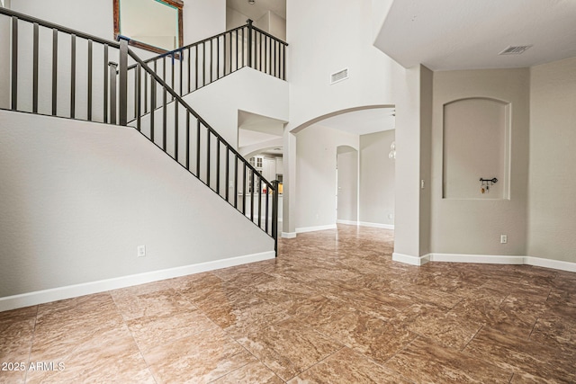 6245 W Maya Dr, Phoenix, AZ 85083 - entrance foyer featuring arched walkways, baseboards, stairs, and a towering ceiling