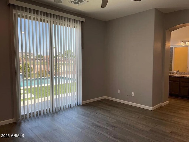 6557 S Classic Way, Gilbert, AZ 85298 - spare room featuring ceiling fan, dark wood-style flooring, and plenty of natural light