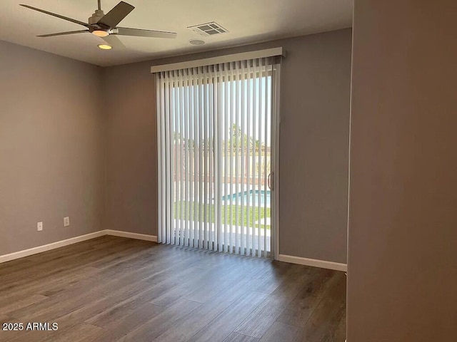 6557 S Classic Way, Gilbert, AZ 85298 - spare room with a ceiling fan, wood finished floors, and baseboards