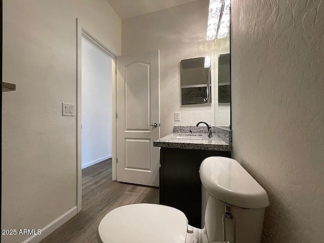 6557 S Classic Way, Gilbert, AZ 85298 - half bath featuring wood finished floors, toilet, baseboards, and vanity