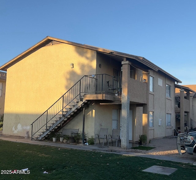 rear view of property featuring a yard