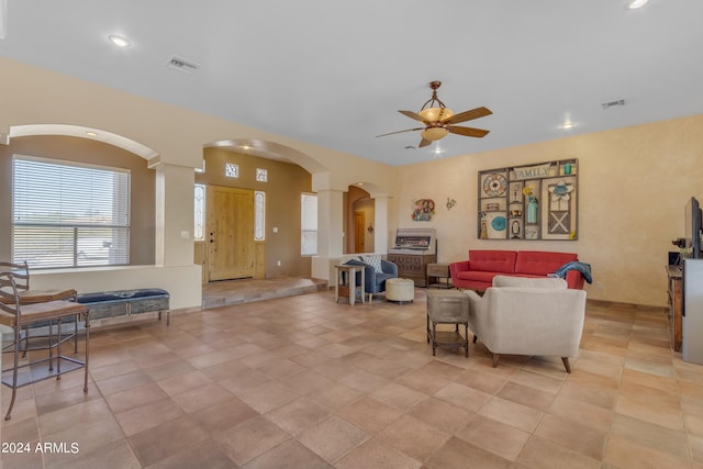 tiled living room featuring ceiling fan