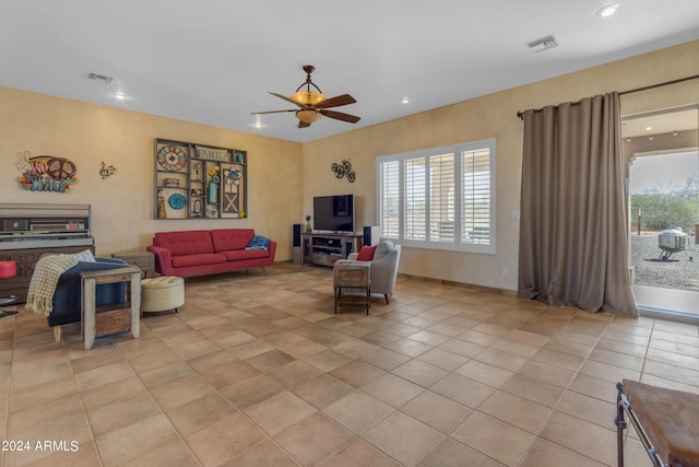 tiled living room featuring ceiling fan