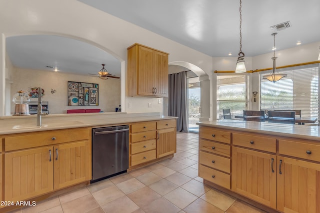 kitchen featuring sink, light brown cabinets, light tile patterned floors, decorative light fixtures, and stainless steel dishwasher