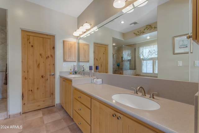 bathroom with vanity, tile patterned floors, and tiled shower