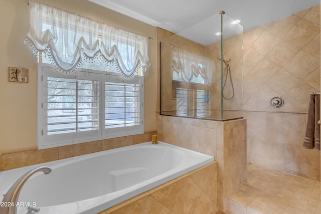 bathroom with shower with separate bathtub