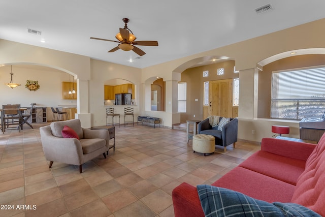 tiled living room with ceiling fan