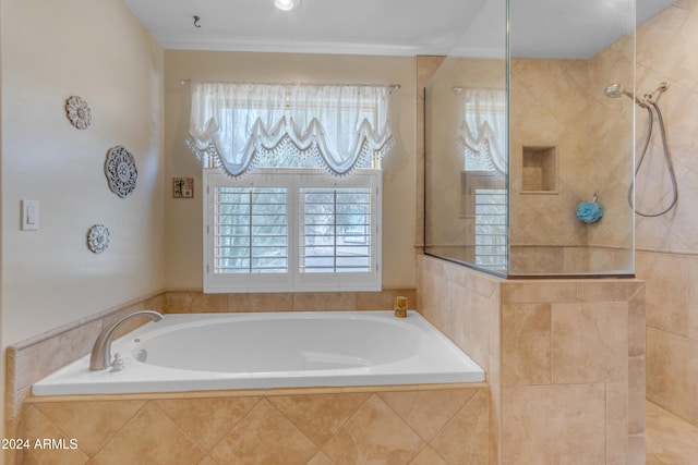 bathroom featuring shower with separate bathtub