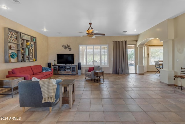 living room featuring light tile patterned floors and ceiling fan