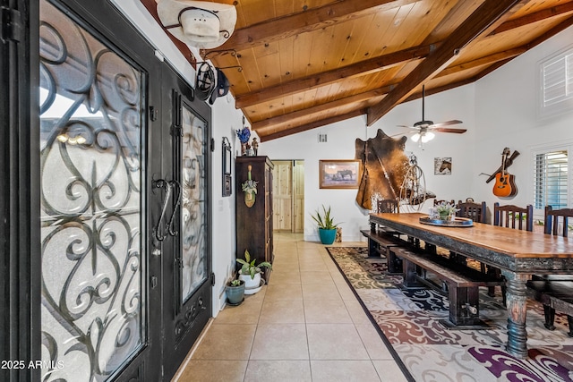 tiled foyer entrance featuring lofted ceiling with beams, wooden ceiling, and ceiling fan