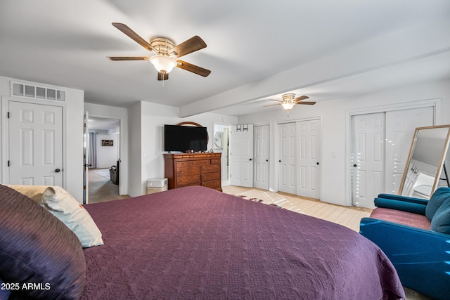 bedroom with two closets and ceiling fan