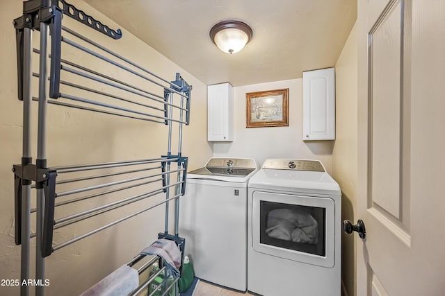 laundry room featuring cabinets and separate washer and dryer