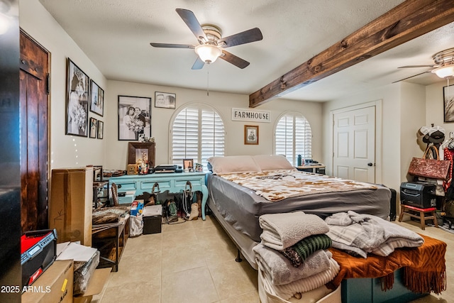 tiled bedroom featuring ceiling fan, beam ceiling, and a textured ceiling