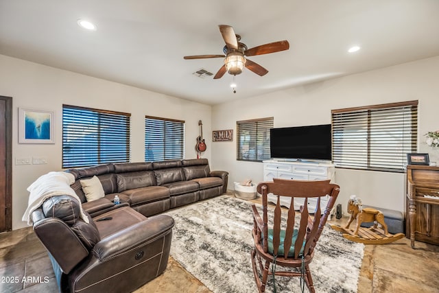 living room with ceiling fan and a healthy amount of sunlight