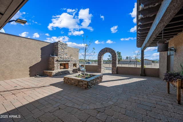 view of patio / terrace with an outdoor stone fireplace