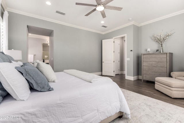 bedroom featuring dark wood-style floors, crown molding, visible vents, and baseboards