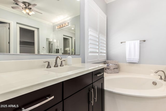 full bath with ceiling fan, ornamental molding, a bath, and vanity