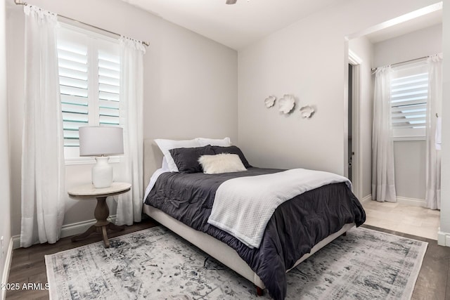 bedroom featuring baseboards and wood finished floors