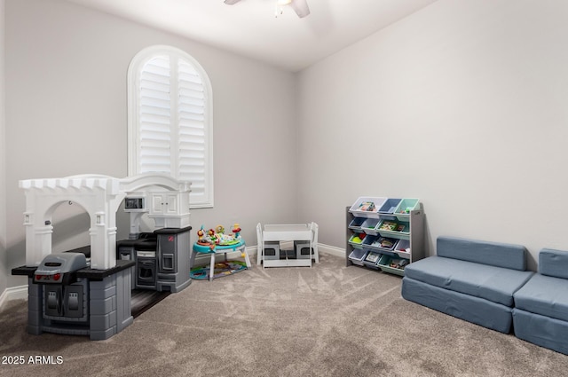 recreation room with carpet floors, baseboards, and a ceiling fan