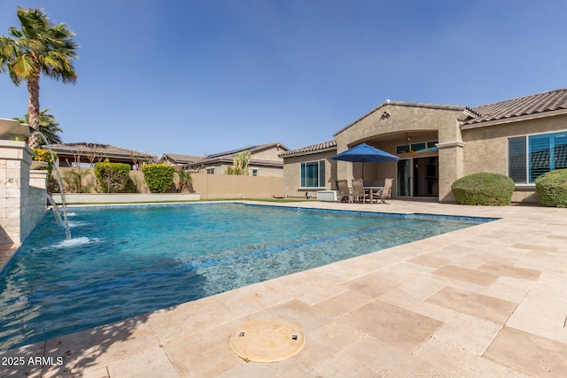 view of swimming pool featuring a patio area, fence, and a fenced in pool