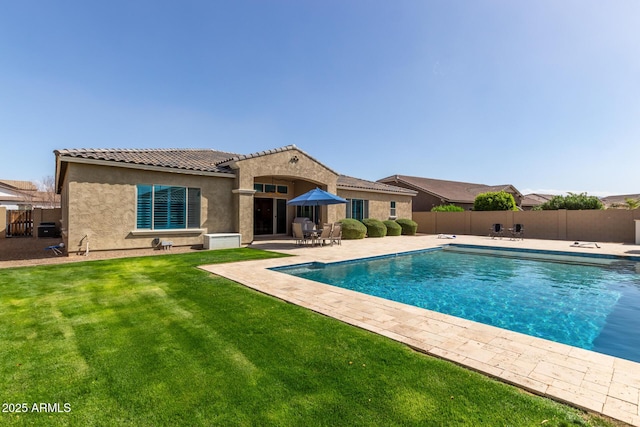 view of pool featuring a fenced in pool, fence, a lawn, and a patio