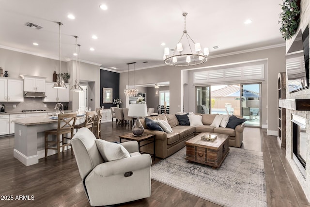 living area featuring a fireplace, visible vents, and dark wood finished floors