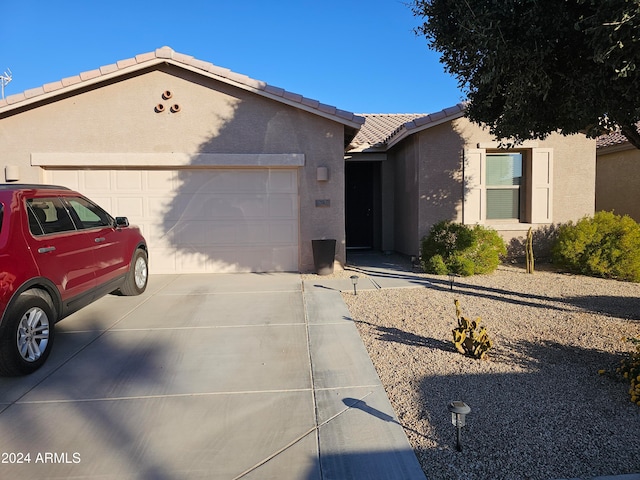 ranch-style house featuring a garage