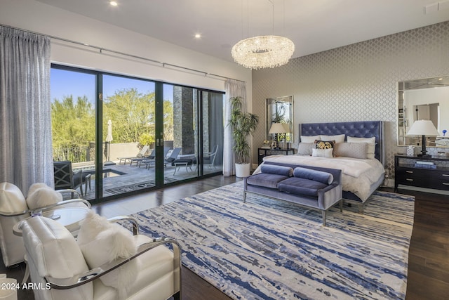 bedroom with access to outside, hardwood / wood-style floors, and a chandelier