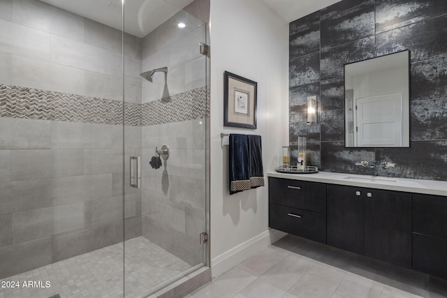 bathroom with vanity, walk in shower, and tile walls