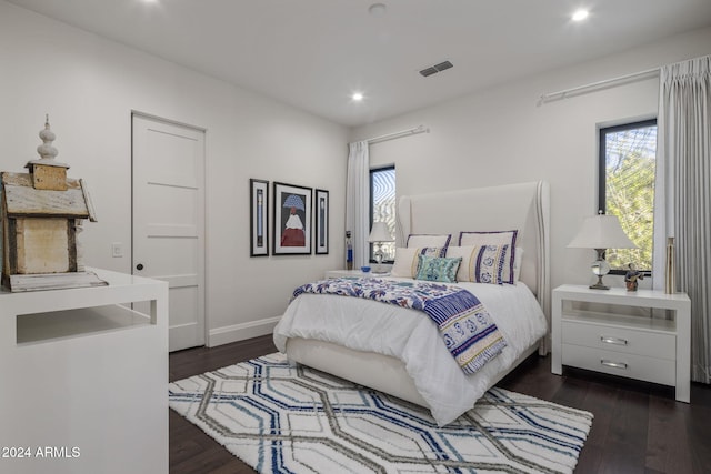 bedroom with dark hardwood / wood-style flooring