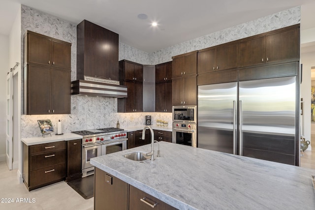 kitchen with dark brown cabinets, custom range hood, and built in appliances