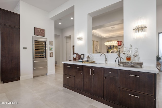 bathroom with vanity, wine cooler, a tray ceiling, and tile patterned flooring