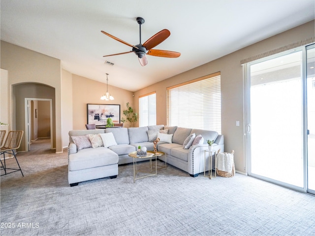 22986 S 208th St, Queen Creek, AZ 85142 - carpeted living room with lofted ceiling, ceiling fan, a chandelier, and arched walkways