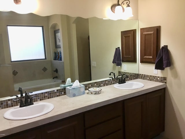 bathroom featuring double vanity, a sink, and decorative backsplash