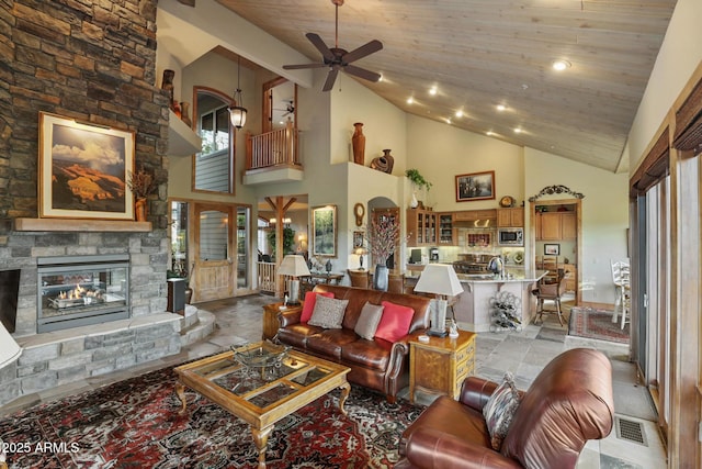 2800 E Morning Glory Cir, Payson, AZ 85541 - living area featuring high vaulted ceiling, a ceiling fan, a stone fireplace, and plenty of natural light